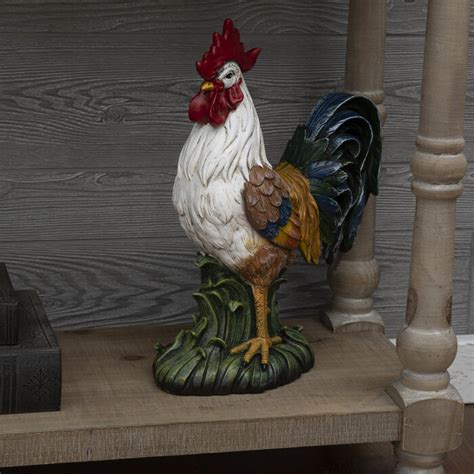 Enhance your farmhouse setting with this good-looking Rooster. This resin rooster stands on a flat base of grass with foam pads. Its body is detailed with grooves, accenting its wings, tail, and legs. The wings and tail feature blue, green, and yellow colors with a whitewashed quality. . 
