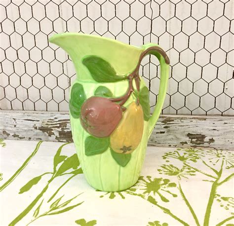 Ceramic pitcher made in 1969. This piece is hand painted and signed by the artist. No cracks or chips. 