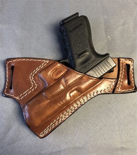 Double magazine holster. Made with the same high-quality, durable 8-10 oz. English bridle leather as all other models. Can be worn on either side of the belt, secured by two 1 & 3/4″ belt loops.. 