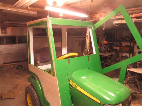 Home built tractor cab. then in the center alley was the perfect low cost plastic top for the homemade cab; ....a square plastic patio table for 15$ (no center hole for the umbrella) so add a couple of sheets of polycarbonate, some "johndeere" green plastic paint, various hardware for the doors and you will have the perfect low cost cab without breaking the bank. 