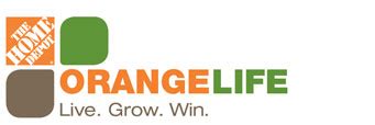 The mark consists of the slanted text "THE HOME DEPOT" in white stenciled lettering inside an orange box to the left of a solid orange box above another solid orange box, all to the left of the word ORANGELIFE in all caps and the words Live. Grow. Win. underneath.. 