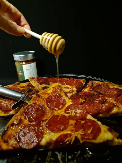 Honey pizza. Preheat the oven to 450 degrees F with a pizza steel or stone. 2. Roll, stretch, spin or pull your prepared pizza dough out to about a 12-inch round on a floured pizza peel. Top with the mozzarella. 3. Then add the sausage, spread evenly over the cheese. Top the sausage with as much feta as you like. 4. 