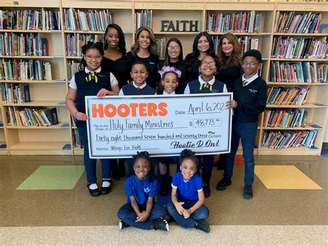 Hooters Presents $48,773 Donation to Holy Family School - Downers Grove …