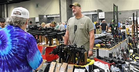 July 25, 2020 at 4:05 a.m. by Tanner Newton. Lee Floyd, right, of Hot Springs, sets up his booth for the South Hot Springs Lions Club Gun and Knife Show at Hot Springs Convention Center Friday .... 