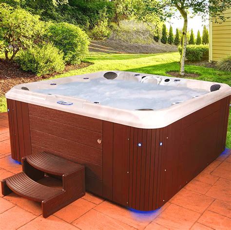 Hot tub cost. A custom inground fiberglass hot tub costs between $10,000 and $20,000, although fiberglass is most often used in prefab shells, priced at $5,000 to $15,000. You'll also need to budget for the cost of extras like covers, built-in steps, extra lighting, jets, and water features. ... 
