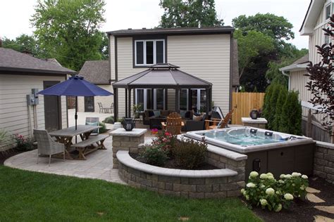Hot tub in backyard. Jacuzzi®️ Hot Tubs are easily one of the most recognizable on the market, with industry-leading technology and a rich history! In fact, this brand was the first to bring hot tubs to the general public, and has been amplifying what you can expect from a spa for over 60 years. This brand offers two hot tubs in the 4-person category. 
