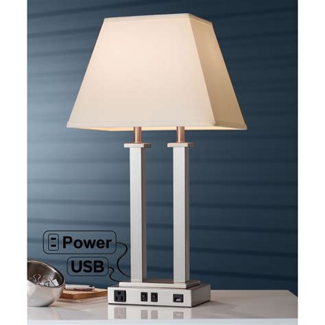 Desk Lamp for Marriott Courtyard Inn. 12” W. x 11" D. x 24" H. Brushed nickel finish. White ribbed drum shade. Shade dimensions D10" x H8". 1 Medium base socket. 1 On/Off rocker switch on base. 2 Convenience outlets on base. USB outlets can be added. . 