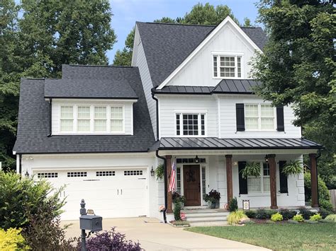 House with black gutters. Black gutters tend to blend in with the look of a home, making them a good choice if you are looking for a more subtle look. Another advantage of black gutters is that they are usually the least expensive option. White gutters will usually stand out more on a home and may be a better choice if you are looking for a contrast to the other colors. 
