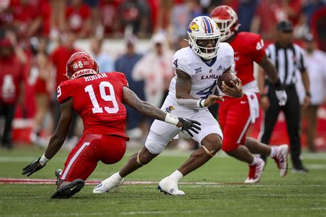 Lightning struck in the Houston area with 9:21 left in the first half, pausing Kansas football's game for 70 minutes. The Jayhawks jumped out to a 21-14 lead over the Cougars one play after the delay. Quarterback Jalon Daniels tossed a 5-yard score to Luke Grimm to take the lead. The Jayhawks' scoring play marked a 21-0 run for the Kansas team.