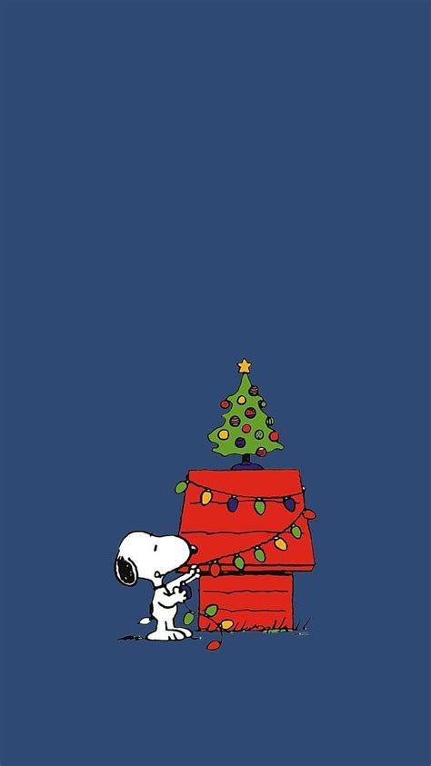 2024 Snoopy sits surrounded by the festive Christmas decorations ready ...