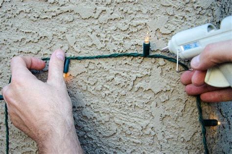 How do you attach christmas lights to stucco. Squeeze the trigger of the glue gun slightly and apply glue. Take your light socket and hold it to your wall for between 3 and 5 seconds. After applying a blob of glue to the first bulb socket, you should press it firmly against the wall until it is securely in place. Let the glue dry and then remove it. 