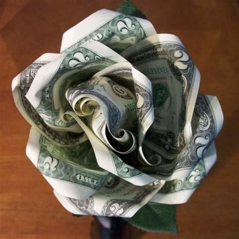 How do you fold money into flowers. Apply glue to the central seam of each piece. This seam is where the folded edges meet (where they were glued together previously). Spread out the glue so that the centers of the pieces can stick together securely. 14. Begin pressing the pieces together. The five cones will make the Kusudama flower’s five petals. 15. 