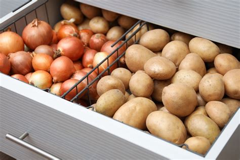 How should potatoes and onions be stored