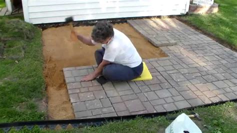 How to build a patio with pavers. Clear the outlined area of any grass, turf and rocks. Add a base of gravel or paver base panels. Next, lay your leveling sand, which will ensure there’s a smooth surface for the pavers to rest on. Once you’ve laid the foundation and the pavers, fill in the gaps with small pebbles or sand of your choice. 