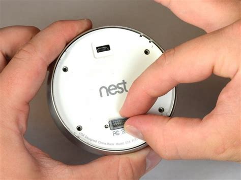 How to change a battery in a nest thermostat. Step 1: Pull off the display of the thermostat. Step 2: Plug the USB port into a wall socket or your laptop. Step 3: you will notice a blinking light when it starts to charge. The color will indicate the battery level. If the battery was fully drained, the thermostat might take almost as long as 2 hours to charge. 