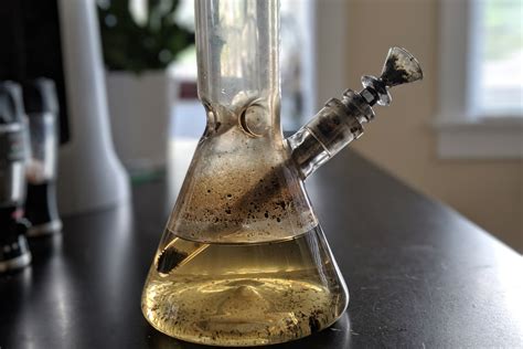 How to clean a bong. Step One: Remove the herb slide carefully and set it aside on top of a hand towel or a thick piece of cloth to prevent it from rolling. Step Two: Let hot water flow through the silicone bong for a few minutes to flush out the old bong water, before putting it back in the water. 
