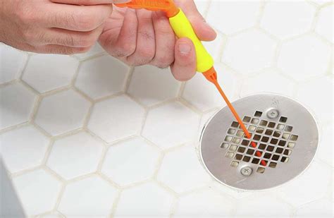 How to clean a shower drain. Rotate the auger in the drain to loosen the nasty gunk on the walls. 3. Flush the drain with hot water to clear out the rest of the clog. Turn on the hot water and let it flow into the drain for several minutes. If the water flows freely down the drain, the clog is gone. 