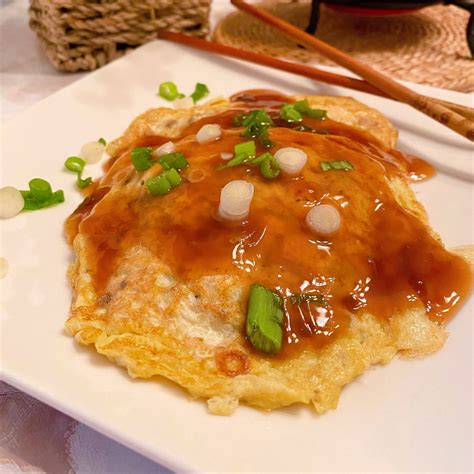 How to cook egg foo yung. To make the egg foo young: Beat eggs in a large bowl then add cooked chicken or cooked shrimp, celery, mushrooms, sliced green onion whites, soy sauce, and sesame oil. Stir until well combined. In a heated wok, add vegetable oil and stir it around coating the sides. Pour about a half cup of the egg foo young batter into the pan. 