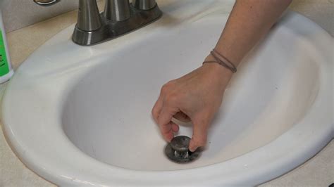 How to get stopper out of bathroom sink. Take the stopper out of the sink. Some older stoppers have a pivot rod that has to be removed. Under the sink, you'll see a locking nut where the rod enters the drain pipe. Remove the nut, and pull the rod out. Have a cleaning rag close at hand when removing the locking nut as a small amount of debris may spill out. 