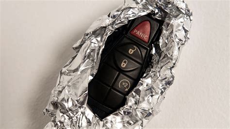 I would only hide the emergency key outside the vehicle and hide the fob inside the car, preferably in a metal box, and as far from the ignition switch as possible. That way if someone finds the outside key. they cannot steal your car. As a worst case scenario, if the battery is dead, at least you will still be able to get in and open the hood.. 