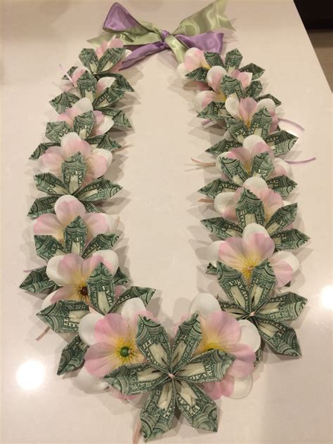 How to make a flower lei with money. Insert the second ribbon loop (the dark blue) inside the previous loop. Pull the previous loop (the light blue) tight. Be careful not to pull the loop so tight that the ribbon buckles. You want the loops to secure each other, but still have the ribbon lei lay flat. 