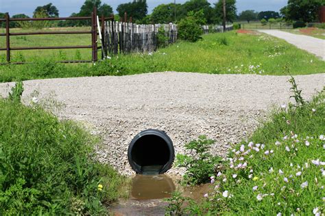 How to put in a culvert pipe. Make sure the tube slopes to drain the water. Check the drainage tubing with a 4-ft. level to make sure you have at least 1/8 in. of slope per foot of tubing (1/2 in. every 4 ft.). Adjust the gravel base as needed. Overlap the sock ends after you connect them. How to Unclog a Toilet. 