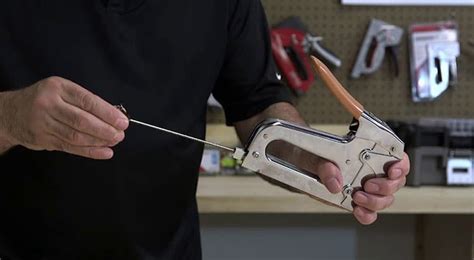 The first step is to ensure that the staple gun is unplugged from any power sources. Next, locate the release latch or button on the staple gun and press or pull it to open the loading chamber. From here, you can insert the staples into the chamber, making sure to line them up correctly with the guidebars.. 