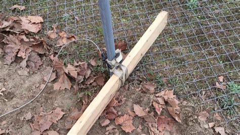  Step #2 – Wrap a chain around the concrete footing of the fence 