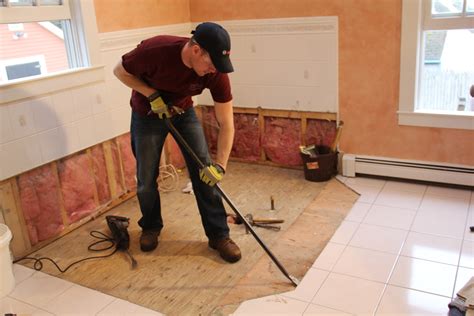 How to remove floor tile. The heat helps loosen tough to remove adhesive. Turn the heat gun to low, allowing it to reach full temperature. Move the heat around the floor in small sections and between the underlayment and the tiles. Pull each section back to remove the tiles. A hair dryer may also work if you can’t access a heat gun. 
