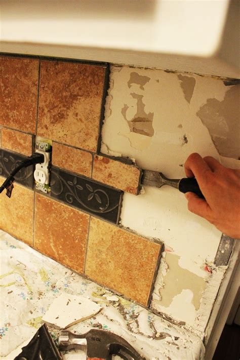 How to remove tile backsplash. Take a chisel and lightly hammer into the grout. Break apart the grout and slowly edge your chisel (or a sharp 6-in-1 tool) underneath the tile. Try to angle your … 
