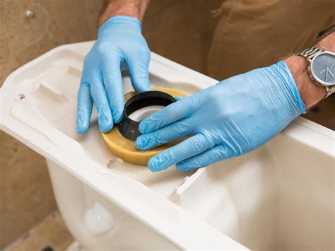 How to replace a toilet. First, clean the hole where the toilet handle goes — inside and outside — with soap, water, and a sponge. Once thoroughly cleaned, dry off the area with a towel. Next, remove the nut from the new toilet handle. Slip the tilt lever all the way into the hole (from the outside). 