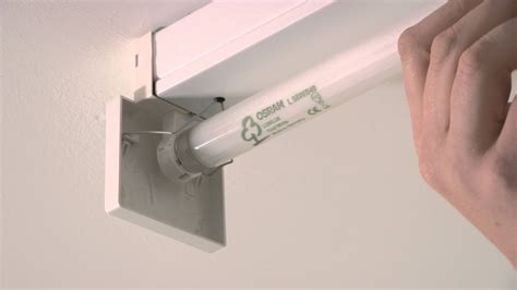 How to replace fluorescent tube light bulb. To remove a wraparound fluorescent light cover, simply grab one long side, push up, and then pull it down. Do the same with the other side. Once you install a wraparound cover replacement or have finished replacing fluorescent light bulbs, secure one long side of the light cover over the lip, then repeat on the other side. 