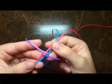 For starting out on lanyards as beginners, we recommend using four strands of plastic scoubidou/scooby-doo strings in two different colors (two strands each color) measuring at least 36 inches long: 1.Begin by crossing all four strings evenly at precisely halfway along their length point.. 