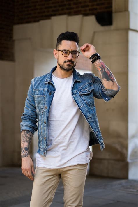 How to style a jean jacket. Simply, add brown boots to complete the overall look. 5. Navy Blue Jeans with a Black Jacket: View Similar Jacket. Black jacket with jeans! Another awesome suggestion we have is to try a durable biker leather jacket with dark blue jeans over a blue sweater or shirt. You can add casual beauty to sunglasses. 