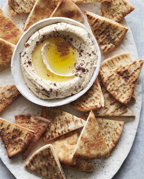 Hummus and pita. Assembly. To a large mixing bowl, add half of the toasted pita, 1/2 the pine nuts, 2/3 remaining warm chickpeas, and pureed hummus mixture. Gently toss to coat and combine. Spoon into a 9×13″ or 8×8″ … 