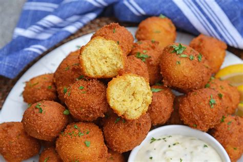 Hush puppies. Ingredients · 2 cups all-purpose flour · 1 cup yellow cornmeal · 1 tablespoon baking powder · 1/2 teaspoon baking soda · 1/2 cup finely chopped o... 