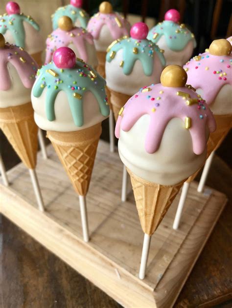 Ice cream cone cake pops. Place your ice cream cone cake in the fridge to set for 10 minutes. Next, you’ll want to make your drip. Melt the colored candy melts according to the package directions. Place the “ice cream” ball in the center of the cake. Use a spoon to pour the chocolate onto the ball and coat it completely. 