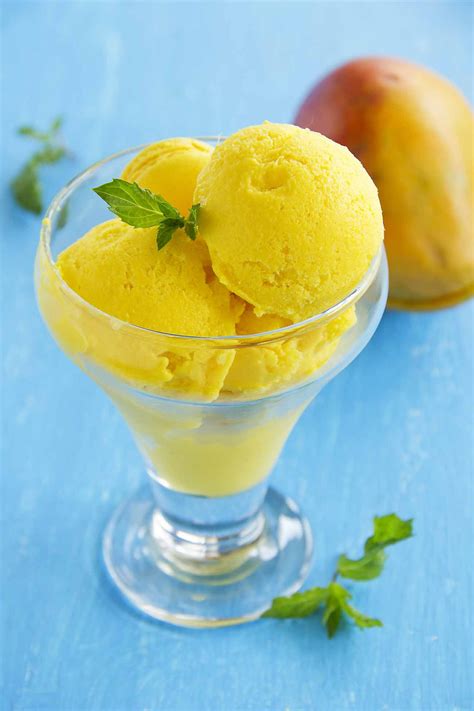 Ice cream mango. Add mango to a blender and process until smooth. Transfer to a non-stick pan on medium low heat. Cook for roughly 10 minutes, stirring frequently until the fruit reduces by half. Refrigerate the puree for two hours or until completely cool. Add sugar, cream, milk, and mango to a large bowl and whisk until well combined. 