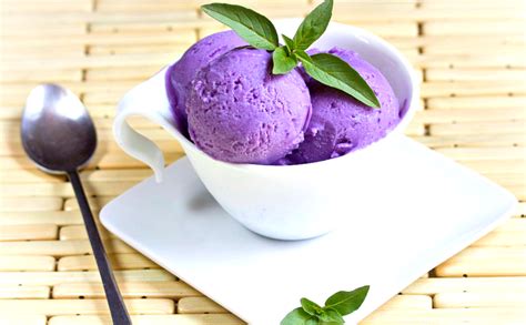 Ice cream taro. Ube and taro, though similar looking on the outside, have noticeable differences. Ube has a bright purple inside while taro has a pale beige flesh with small purple specks. Ube is also much sweeter and used more often in desserts. Taro is savory and used more frequently as a substitute for potatoes. There are even more differences beyond that ... 