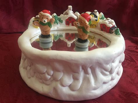 Source eBay. 1980's Otagiri Christmas Porcelain Ice Skating Teddy Bear Music Box This sweet hand-painted porcelain music box by Otagiri features an ice skating teddy bear in a santa suit. Wind it up and it plays "The Skaters Waltz". While the music plays the little bear twirls and skates in a circle on the mirrored "ice". This really is adorable.. 