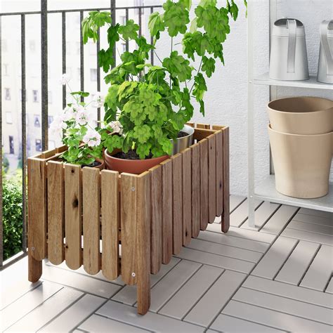 Ikea raised planter. Easy Window Planter. You can build this wooden planter box in less than an hour. You’ll need to cut out holes with a jigsaw and attach the outdoor planter boxes to the house with some screws. Use the clay pots to add some color and up your home’s curb appeal. Here are some more ways to add curb appeal for less than $50. 