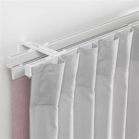 Ikea vidga curtain track. Comprises: 3 holders for panel curtains, 2 wall fittings, 1 triple track rail (length 140 cm), 1 single track rail (length, 140 cm), 1 glider/hook package. 1 package includes gliders and hooks for 1 standard-size curtain. 2 packages are required for a curtain pair, a wider curtain or if you want to create many tight pleats. 