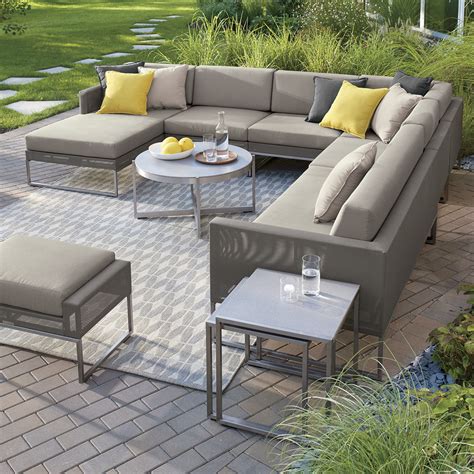 Indoor patio furniture. This bright and airy sunroom demonstrates a savvy mix of patterns and colors. Upholstered rattan chairs offer a counterpoint to the white slipcovered sofa, which is decorated with an eclectic mix of textured pillows. Underfoot, a geometric area rug splashes bold color across dark painted floors. 07 of 18. 