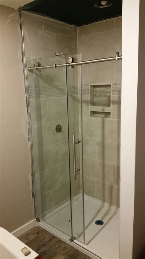 Install glass shower door. By following these 5 simple steps, you can easily install the glass shower door by yourself: Measure the space accurately. Drill the holes on the wall. Hold the stationary glass panels together. Attach the swing door panel to the side rail. Install the shower door sweep on the bottom. 
