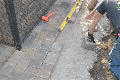 Install pavers. Nov 17, 2022 · Learn how to install outdoor flooring by yourself with patio pavers, a cost-effective and simple option for walkways, patios, and pools. Follow the easy steps to prepare the ground, lay the base material, add the sand, and lay the pavers in 9 easy steps. 