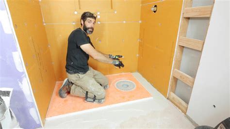 Installing a schluter shower pan. Steve Smith. For tile or shower panels, drywall goes in first. Installing a shower pan includes many steps, such as cementing the floor to create a sturdy base and installing the shower walls. When putting up your shower walls, be sure to follow the proper installation procedures to create a watertight seam between the shower pan and wall. 