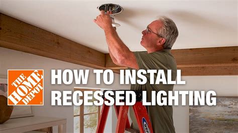 Installing can lights. Cut out the hole using a utility knife or a keyhole saw. Carefully brush the opening lightly with a cloth to remove any loose particles. Return the panel to the opening in the ceiling then remove the next panel over from the one with the hole. Slide the light into place over the hole and attach the housing to the supports. 
