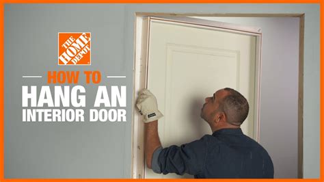Interior door installation. Penetrate through the jamb and shim, making sure the frame remains square and plumb. Drive another nail roughly 6 inches above the bottom of the frame. Drive a third nail into the middle. Follow these same steps to secure the lock side of the door. Use a shim behind each nail and trim them with a utility knife. 