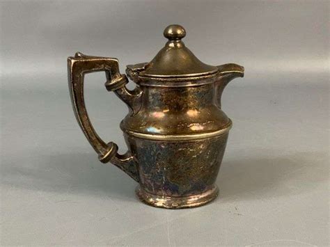 Seven-piece coffee and tea service with associated tray. c. 1861-68, silver. 14 h × 9½ w × 8¼ d in. result: $10,400. estimate: $10,000–15,000. Service is comprised of a kettle on stand, coffee pot, teapot, chocolate pot, covered sugar bowl, cream jug and waste bowl featuring floral repoussé decoration and Chinese figural finials.