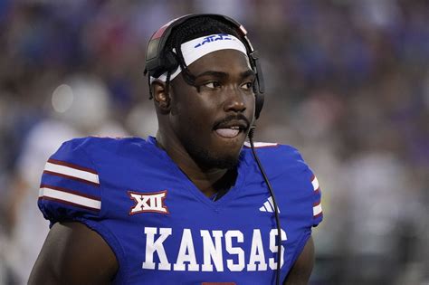 The NIL era of college football has led to a lot of wild moments over the past two years, and Jalon Daniels’ Big 12 Media Days drip sits near the top. Kansas’ starting quarterback pulled up to Arlington, Texas with some serious bling around his neck. Jalon Daniels brought the ice! (Photos by Jay Biggerstaff/Getty Images/Kansas Athletis). 